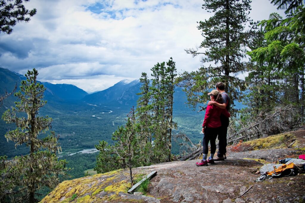 Couple standing on the top of the mountain
